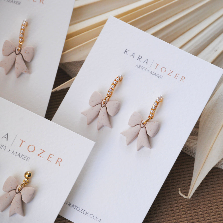 Neutral Pearl Bow Dangles